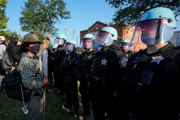A protesters co<em></em>nfronts police during a demo<em></em>nstration at the Democratic Natio<em></em>nal Co<em></em>nvention Monday, Aug. 19, 2024, in Chicago.