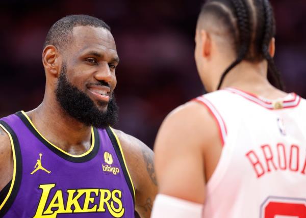 LeBron James #23 of the Los Angeles Lakers looks at Dillon Brooks #9 of the Houston Rockets