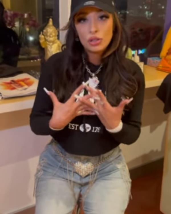 Singer Claudia Jennings, known as Loomis, sitting on a stool, apologizing on Instagram after botching Natio<em></em>nal Anthem performance