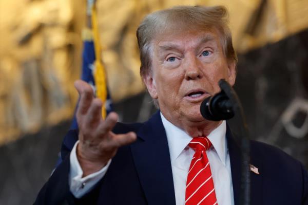 Do<em></em>nald Trump speaking into a microphone at the Internatio<em></em>nal Brotherhood of Teamsters headquarters in Washington, D.C.