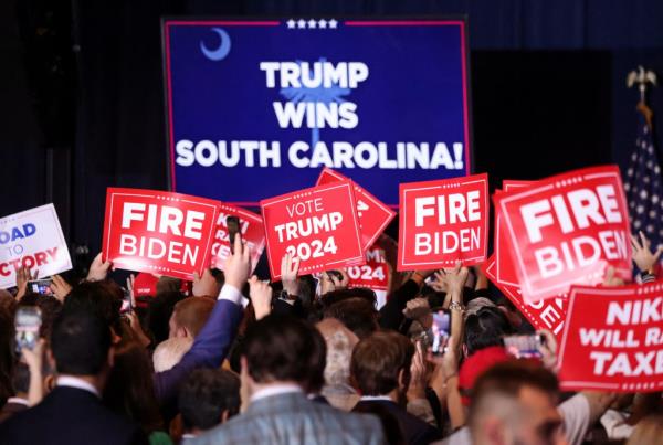 Supporters of Do<em></em>nald Trump with signs at a Republican primary election party in South Carolina, US.