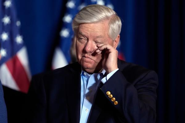 Lindsey Graham wiping his eye while Do<em></em>nald Trump speaks at an election night party in South Carolina.
