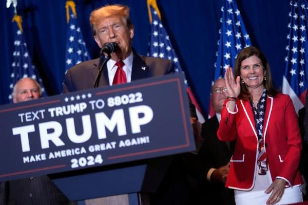 Do<em></em>nald Trump speaking at primary election party, South Carolina Lt. Gov. Pamela Evette waving beside him.