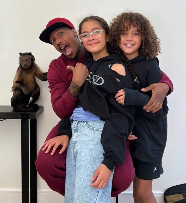 Nick Cannon hugging daughter Mo<em></em>nroe Cannon and son Moroccan Cannon, 12.