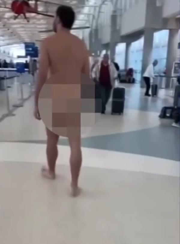 A naked man walking through a check-in lane at an airport