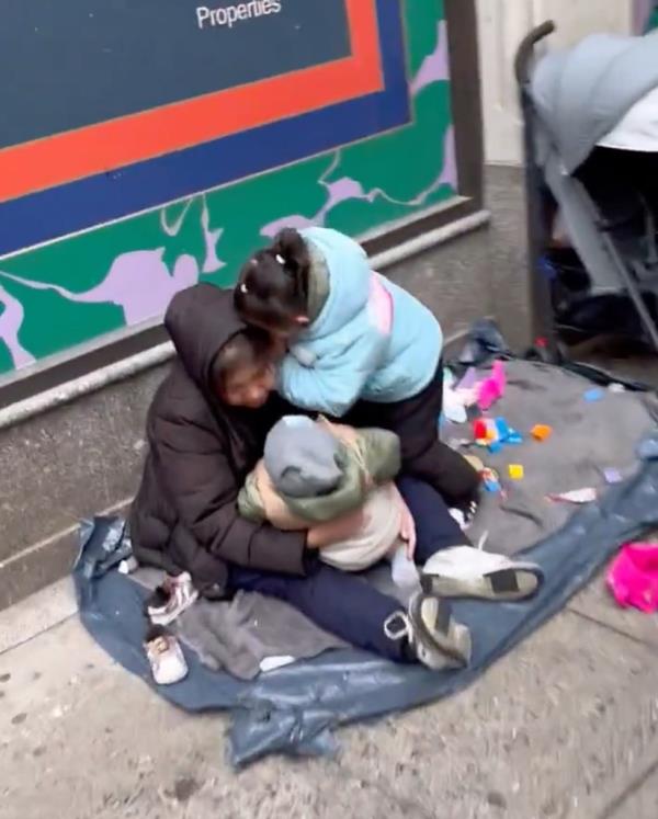 Migrant family living on sidewalk. 