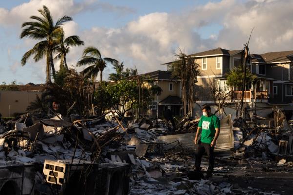 A Mercy Worldwide volunteer makes a damage assessment of a charred apartment complex in the aftermath of a wildfire in Lahaina on Saturday.