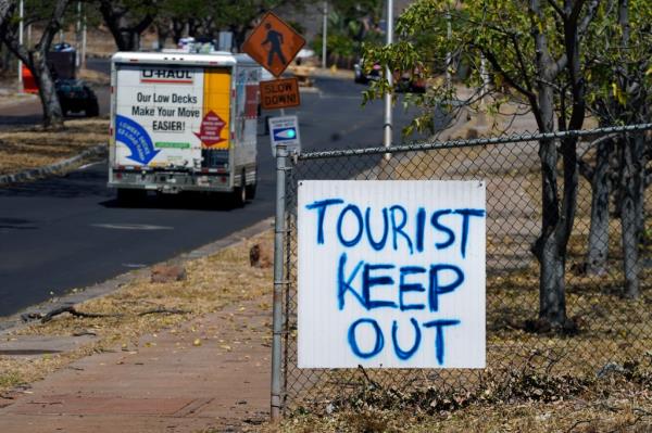 A sign displayed in Lahaina, Hawaii, on Sunday after a deadly wildfire that caused heavy damage days earlier.