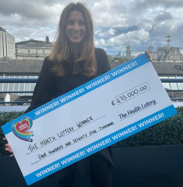 Carly with a big lotto winners cheque