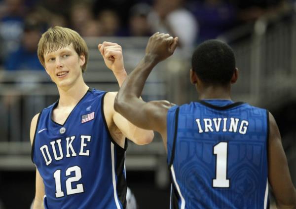 Kyle Singler #12 of the Duke Blue Devils is co<em></em>ngratulated by Kyrie Irving #1 after scoring during the CBE Classic champio<em></em>nship game on November 23, 2010