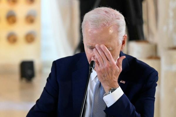 Biden with his hand on his face