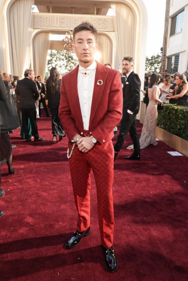 Barry Keoghan wearing a red suit and a brooch at the 81st Golden Globe Awards in Beverly Hills, California