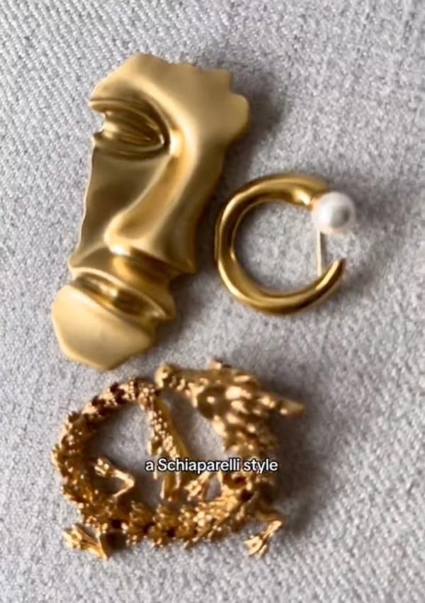 A gold brooch and earrings, popular accessories among Gen Z, as highlighted in a style hack video on TikTok by user @kimmeelee.