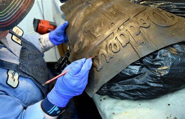 An employee at Art Castings of Colorado touches up a wax mold of Jackie Robinson's jersey in Loveland, Colo. on Wednesday, May 8, 2024. 