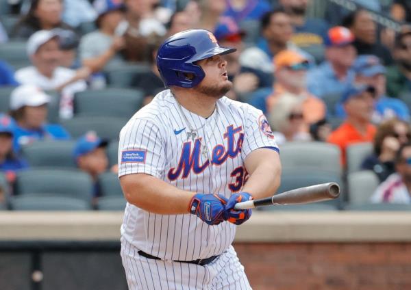 A ba<em></em>seball player, Dan Vogelbach, hitting a three run RBI double with a bat during a game between the Cincinnati Reds and the New York Mets.