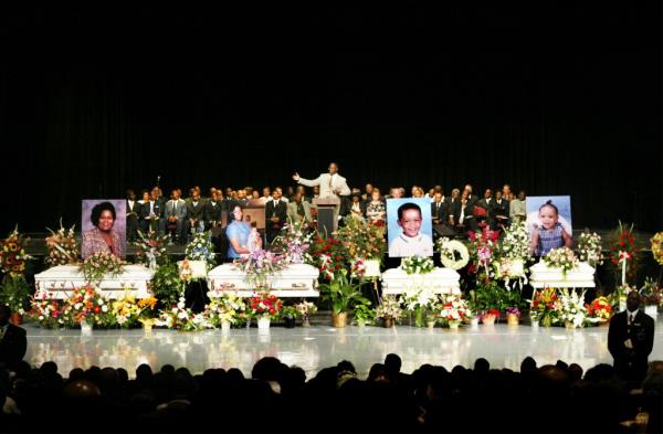  The Rev. Eddie L. Harper gives the eulogy at the funeral for five of his family members who were found shot to death in their home last week July 16, 2003
