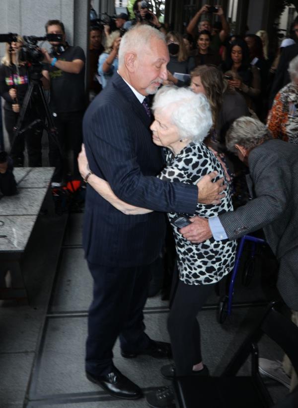 Menendez family member hugging Menendez brothers' attorney Mark Gerragos