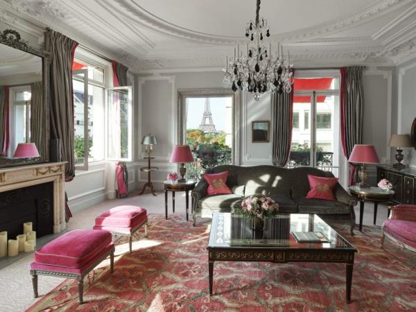 Elegantly furnished room in Hotel Plaza Athenee Paris, featuring French Regency or Art Deco style with a chandelier and a couch