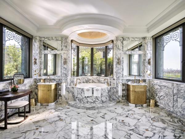 Impeccably decorated room in Le Meurice, Paris with a large marble-adorned bathroom