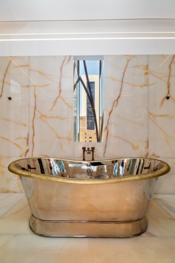 The tub dazzles with polished nickel.