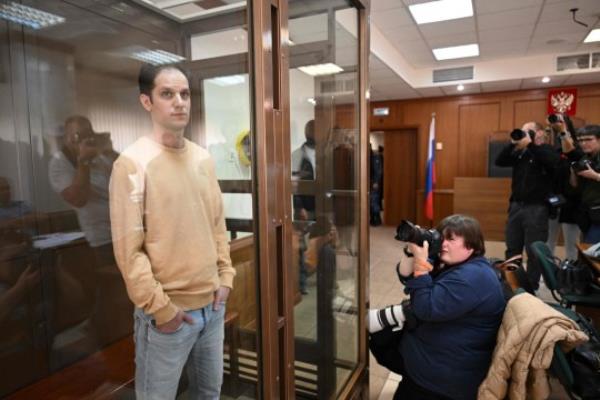 TOPSHOT - US journalist Evan Gershkovich, arrested on espio<em></em>nage charges, stands inside a defendants' cage before a hearing to co<em></em>nsider an appeal on his extended pre-trial detention at the Moscow City Court in Moscow on September 19, 2023. Gershkovich was detained in March during a reporting trip to the Urals and accused of spying -- charges that he, the US government and his employer, the Wall Street Journal, vehemently deny. In August his pre-trial detention was extended by three months. (Photo by NATALIA KOLESNIKOVA / AFP) (Photo by NATALIA KOLESNIKOVA/AFP via Getty Images)