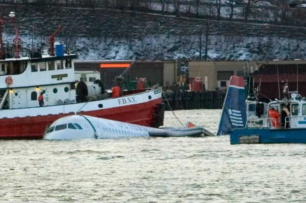 A US Airways plane is guided down the Hudson River