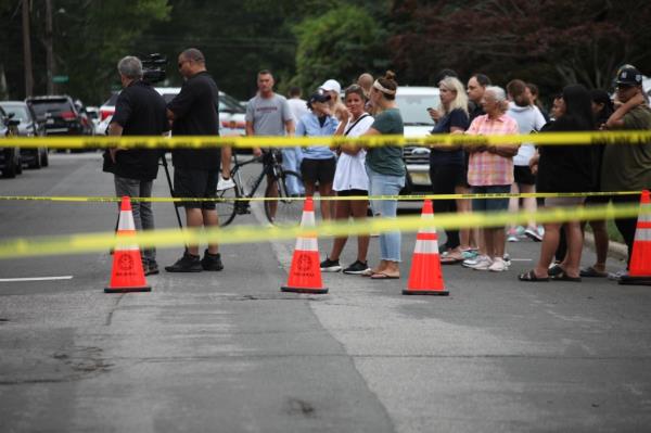 Neighbors crowd around Heuermann's Massapequa Park home after news of his arrest broke.