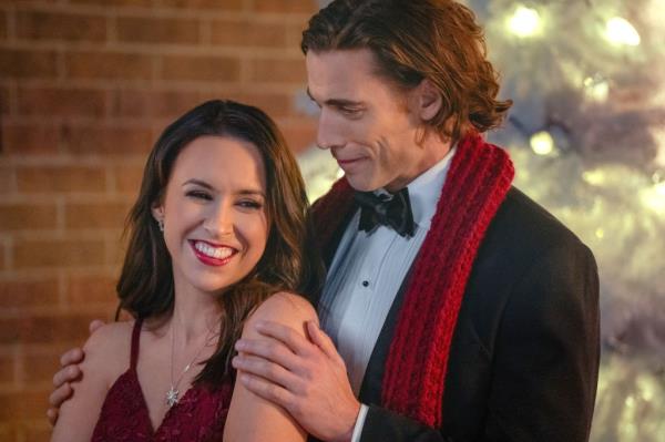 Lacey Chabert smiling with Dustin Milligan