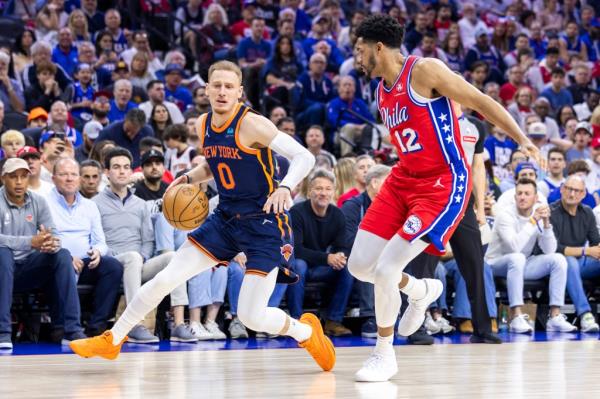 Do<em></em>nte DiVincenzo #0 of the New York Knicks drives down court as Tobias Harris #12 of the Philadelphia 76ers gives chase