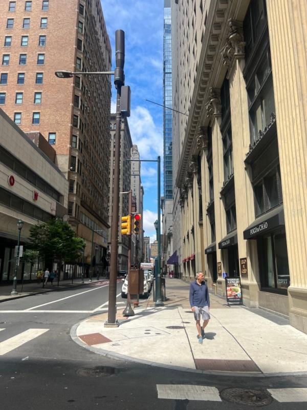 Person walking on a clean sidewalk in Downtown Philadelphia. 