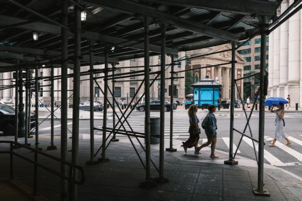 People walking beneath the extensively scaffolded 2 Lafayette St in Manhattan, New York.