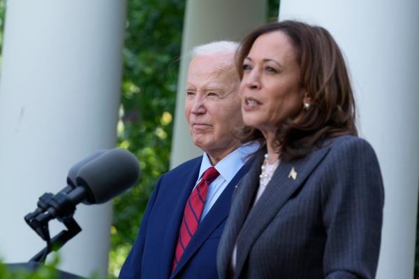 President Joe Biden listens as Vice President Kamala Harris speaks in the Rose Garden of the White House