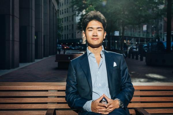 Calvin Yang sitting on a bench