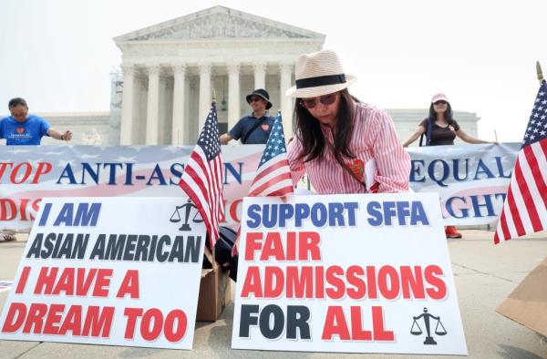 Protesters with signs outside the Supreme Court, in support of Students for Fair Admissions