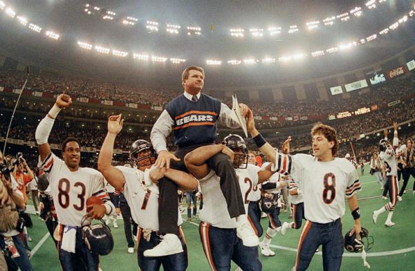 Chicago Bears coach Mike Ditka being carried off the field by players Steve McMichael and William Perry after winning Super Bowl XX.