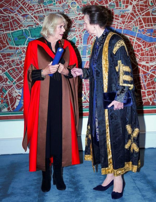 Queen Camilla reacting while receiving an Ho<em></em>norary Doctorate, with Princess Anne standing by her side at the University of London