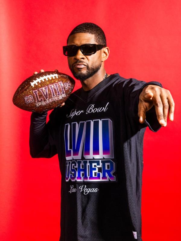 Usher posing with a football ahead of his 2024 Super Bowl performance.