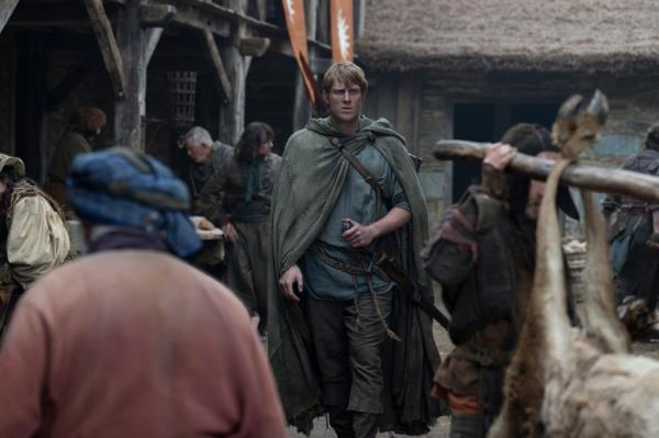 Peter Claffey walking in a medie<em></em>val looking village. 