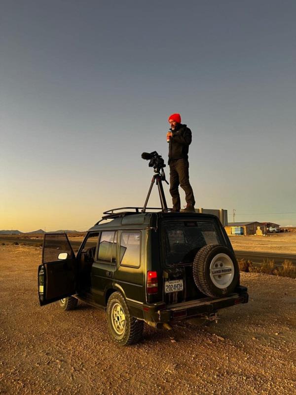 McDo<em></em>nnell stands on top of his car during a shoot.