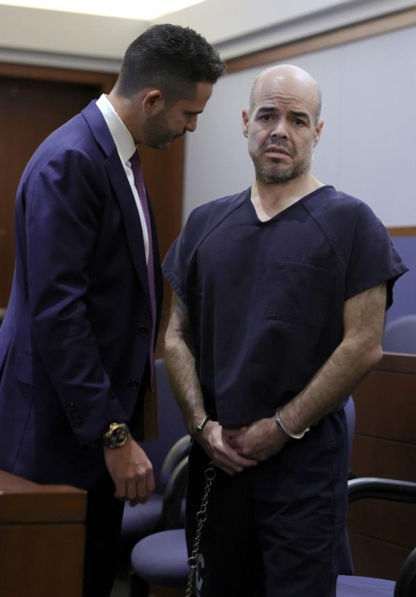 Clark County public defender David Lopez-Negrete (L) talks with Clark County Public Administrator Robert Telles as he appears in court for an arraignment on an open murder charge in Las Vegas Justice Court at the Regio<em></em>nal Justice Center on September 20, 2022