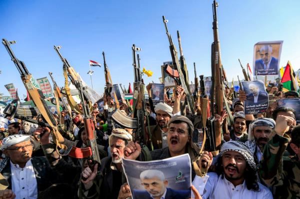 Supporters of Yemen's Huthis gather with pictures of Hamas' slain leader Yahya Sinwar during a rally held in the Huthi-co<em></em>ntrolled capital Sanaa on October 18, 2024 in protest against Israel's attacks on Lebanon and the o<em></em>ngoing war between Israel and Hamas militants in the Gaza Strip.