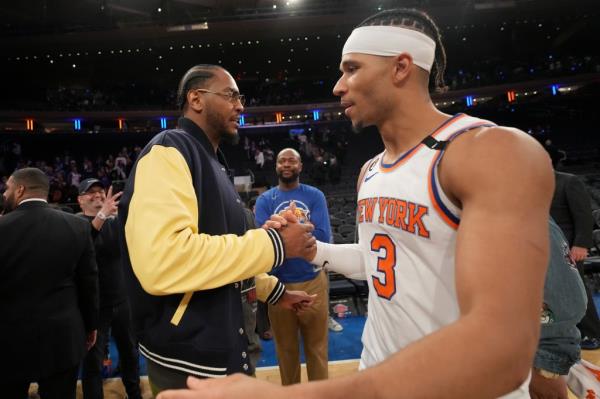 Carmelo Anthony embraces Josh Hart #3 of the New York Knicks