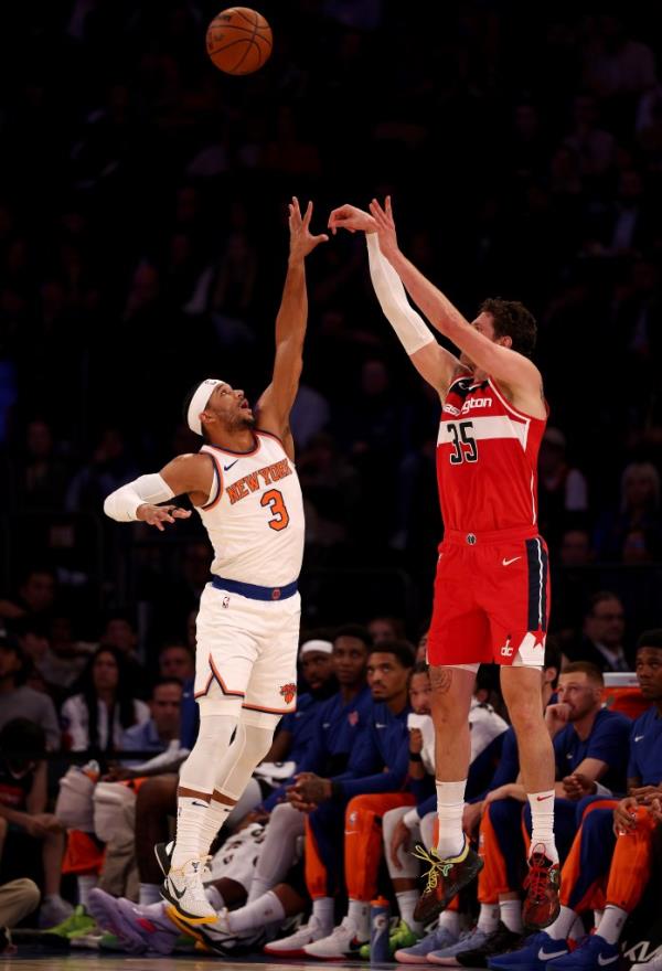 Mike Muscala #35 of the Washington Wizards takes a shot as Josh Hart #3 of the New York Knicks defends 