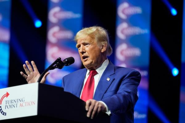 Former President Do<em></em>nald Trump speaking into a microphone during a campaign rally at Thomas & Mack Center in Las Vegas, 2024