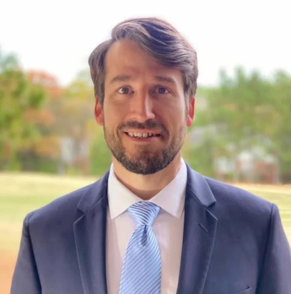 Bank of America associate Leo Lukenas in suit and tie, who reportedly worked 100-hour weeks prior to his death from a blood clot