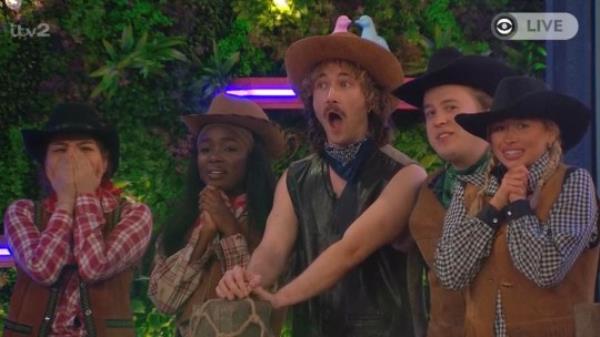 Big Brother co<em></em>ntestants wearing cowboy outfits.