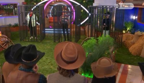 Big Brother co<em></em>ntestants stood in fake jail cells. 