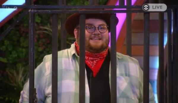 Big Brother co<em></em>ntestant Jenkin dressed like a cowboy and stood behind fake prison bars,