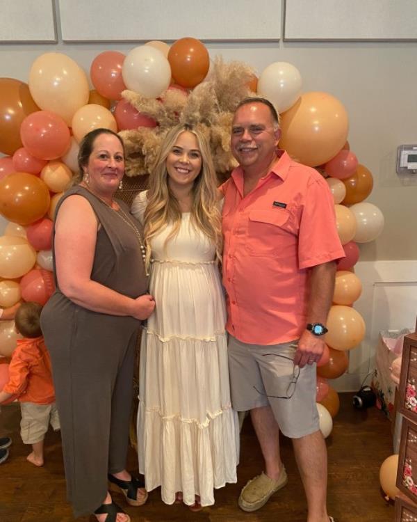 Megan with her parents at her baby shower 