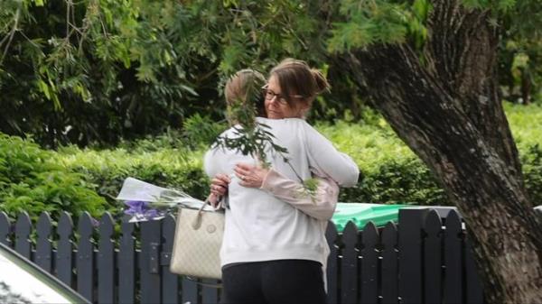 Anto<em></em>nia is pictured hugging a friend near her mother’s house on Sunday afternoon.